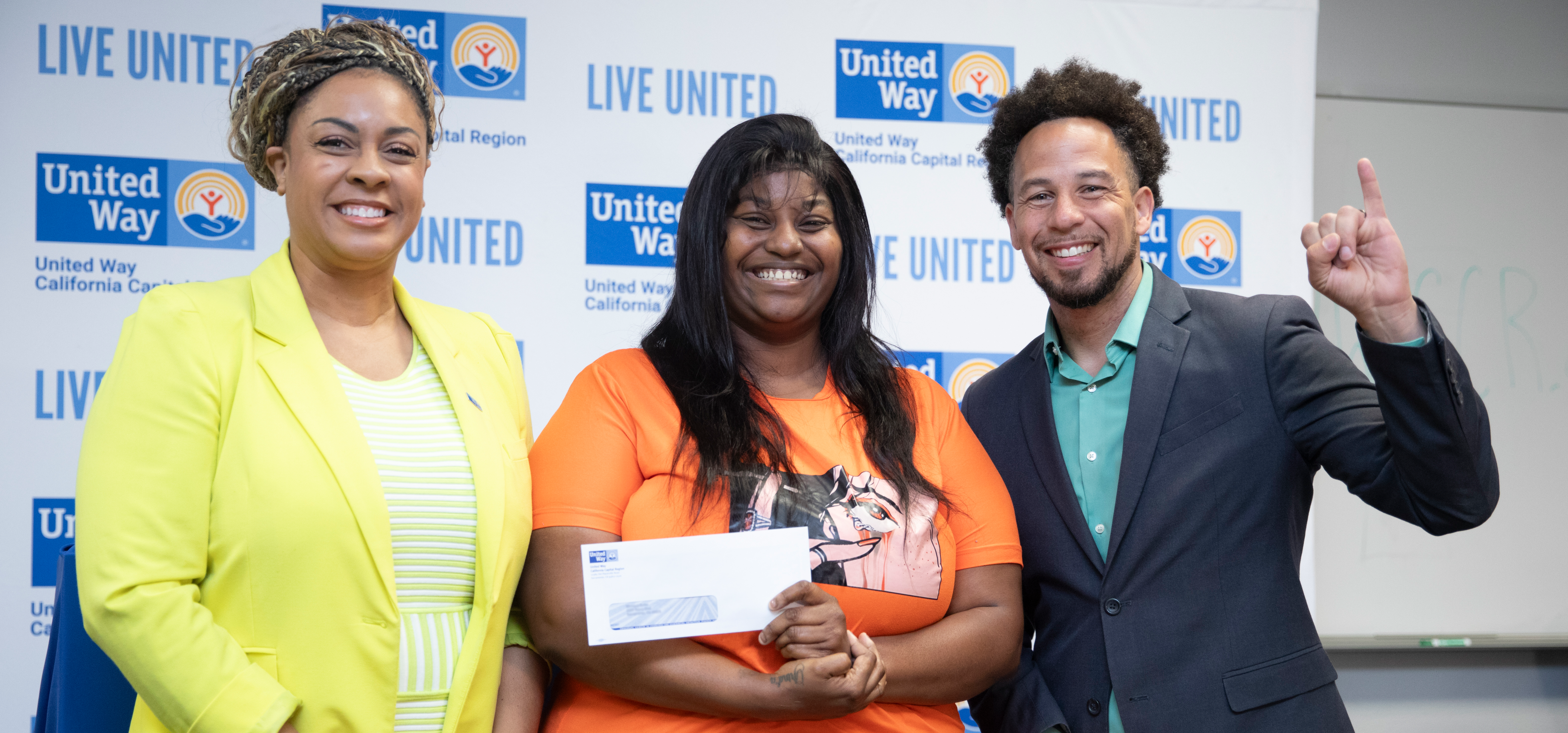 Dr. Early of United Way and Dr. Wood of Sac State pose with one of the recipients of the Collegiate Guaranteed Income Program