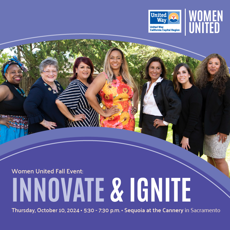 Seven women stand together outdoors, smiling, promoting the Innovate & Ignite event.