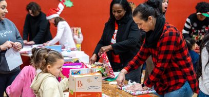 Volunteers wrap gifts during our Season of Giving Holiday Market