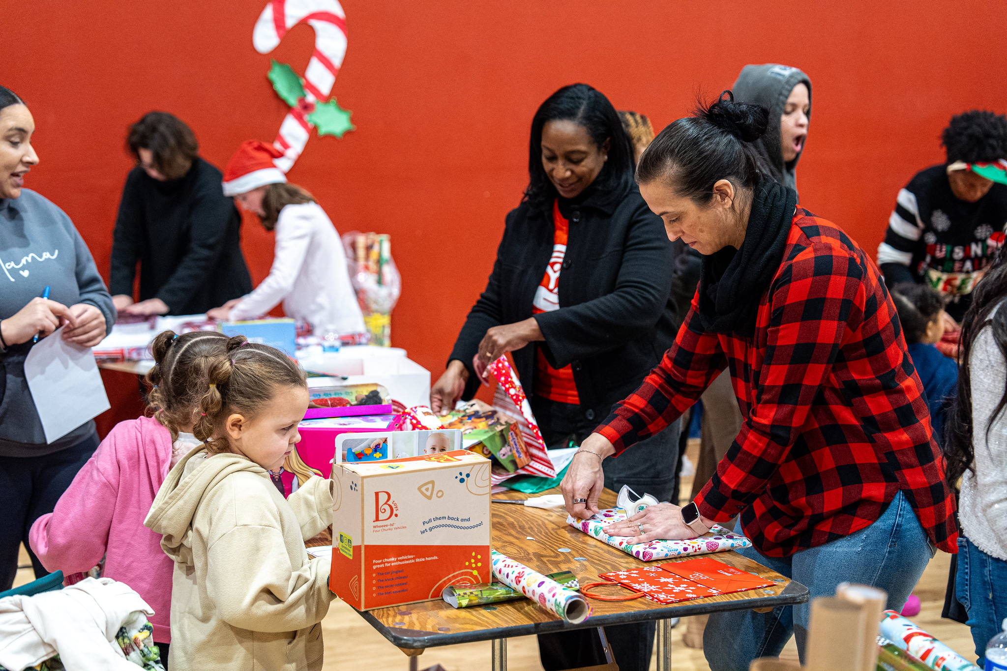 Volunteers wrap gifts during our Season of Giving Holiday Market